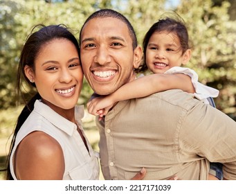 Portrait Of Mom, Dad And Girl At The Park Having Fun, Bonding And Playing Together On Weekend. Summer, Love And Multicultural Family Enjoy Sunny Day In Nature, Garden And Outdoor With Smile On Face