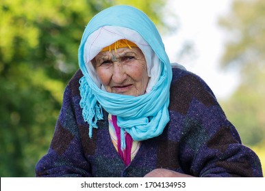 Portrait Of A Moroccan Woman Dressed In Typical Moroccan Attire, And Tattoo In Her Face, And In The Background Nature.