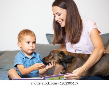 Portrait of mother and baby with their pet dog (real family).