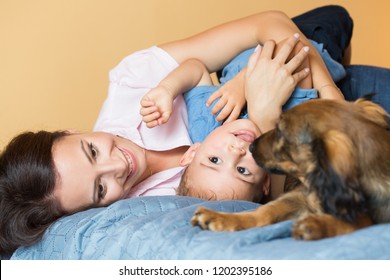 Portrait of mother and baby with their pet dog  (real family).