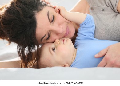 Portrait Of Mother Cuddling Baby Boy