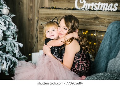 portrait of mother with daughter with christmas tree on background - Shutterstock ID 773905684
