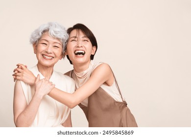 Portrait of mother and daughter hugging and laughing - Powered by Shutterstock