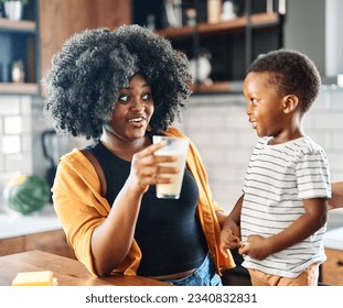 Portrait of mother, father and son  preparing and eating breakfast and drinking milk  in the kitchen at home - Powered by Shutterstock