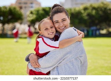 Portrait Of Mother And Girl Hug At Soccer Training, Bonding And Embracing On A Field. Sport, Fitness And Support By Parent For Child Hobby And Passion, Enjoying Morning Activity And Football Outdoor