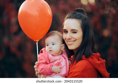 Portrait Of A Mother And Her Baby Daughter With A Red Balloon
Proud Mom Holding Her Child Celebrating Together
