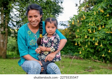 Portrait of mother with her daughter looking at the camera.