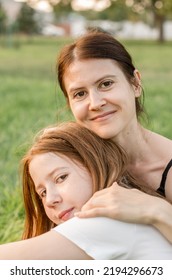 Portrait Of A Mother With Her Daughter In Nature. Mom Hugs Her Daughter