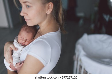 Portrait Of Mother And Her Newborn Baby.