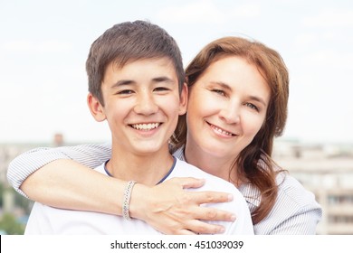 Portrait Of A Mother With Her Son Teenager. Tenderness, Love, Multinational Family