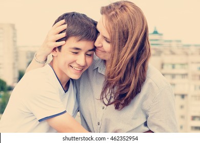 Portrait Of A Mother With Her Son Teenager. Tenderness, Love, Multinational Family