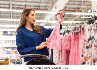 Portrait of mother relax and enjoy shopping time walk to buy something purchases and choosing baby and children clothes in a kid store shop.fashion kid shopping concept - Powered by Shutterstock