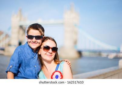 Portrait Of A Mother And Son In Front Of Tower Bridge In London