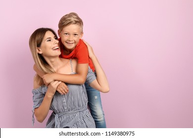 Portrait Of Mother And Son On Color Background