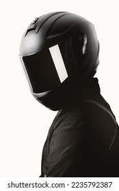 Portrait of a motorcycle rider posing with a black helmet on a white background. - Shutterstock ID 2235792387