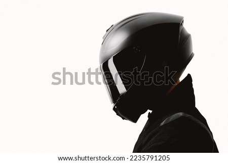 Portrait of a motorcycle rider posing with a black helmet on a white background. Imagine de stoc © 