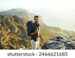 Portrait, mountains and hiking with man, walking and journey with nature, fitness and getaway trip. Hobby, person and hiker with backpack, adventure or environment with happiness, holiday or vacation