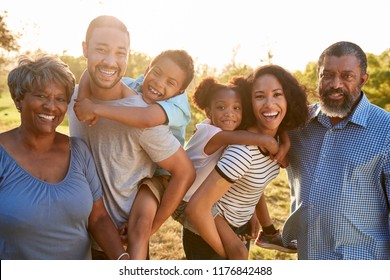Portrait Of Multi Generation Family Enjoying Walk In Park Together