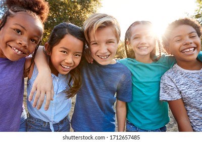 Portrait Of Multi-Cultural Children Hanging Out With Friends In Countryside Together
