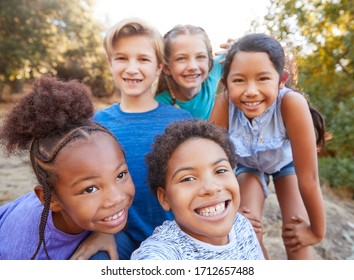 Portrait Of Multi-Cultural Children Hanging Out With Friends In Countryside Together