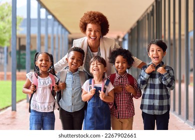 Portrait Of Multi-Cultural Elementary School Pupils With Female Teacher Outdoors At School - Shutterstock ID 2267902661