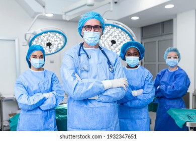 Portrait Of Multi-Cultural Medical Team Standing In operating theatre. Portrait of successful medical workers in surgical uniform in operation theater, ready for next operation. - Powered by Shutterstock