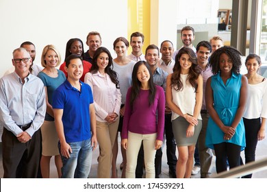 Portrait Of Multi-Cultural Office Staff Standing In Lobby - Shutterstock ID 174539291