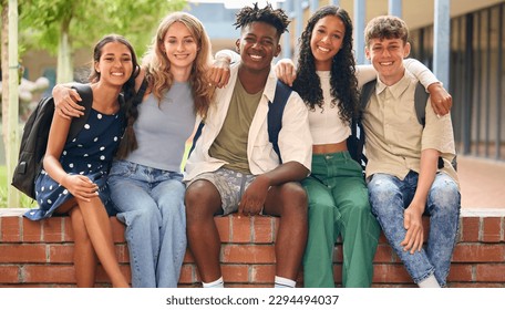 Portrait Of Multi-Cultural Secondary Or High School Students Sitting On Wall Outdoors At School - Powered by Shutterstock