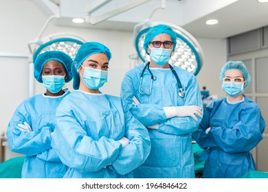 Portrait Of Multi-Cultural Surgical Team Standing In Hospital Operating Theater - Powered by Shutterstock