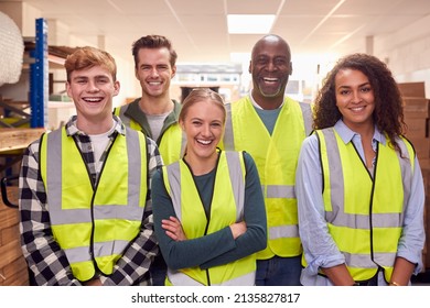 Portrait Of Multi-Cultural Team Wearing Hi-Vis Safety Clothing Working In Modern Warehouse - Powered by Shutterstock