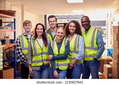 Portrait Of Multi-Cultural Team Wearing Hi-Vis Safety Clothing Working In Modern Warehouse - Powered by Shutterstock