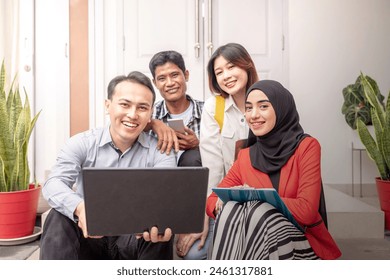 Portrait of multiethnic business colleagues discussing a business project plan during a meeting at the cafe - Powered by Shutterstock