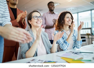 Portrait of multi-ethnic business team clapping happily listening to  presentation in office, copy space - Shutterstock ID 1356197924