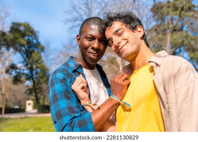 Portrait of multiethnic gay male couple on a romantic walk in the park, lgbt concept - Powered by Shutterstock