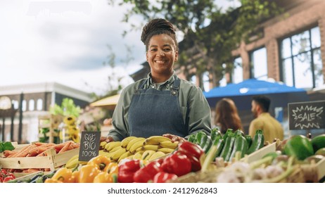 Portrait of a Multiethnic Middle Aged Female Managing a Street Vendor Food Stand with Fresh Organic Agricultural Products. Happy Stylish African Farmer is Looking at Camera and Charmingly Smiling - Powered by Shutterstock