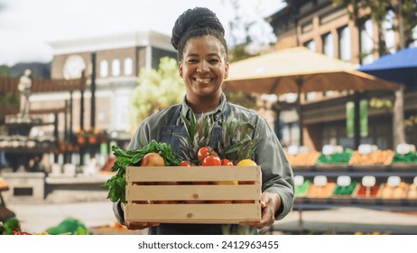 Portrait of a Multiethnic Middle Aged Female Managing a Street Vendor Food Stand with Fresh Organic Agricultural Products. Happy Stylish African Farmer is Looking at Camera and Charmingly Smiling - Powered by Shutterstock