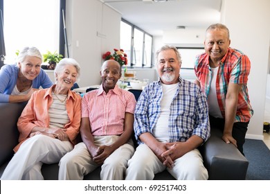 Portrait of multi-ethnic senior people sitting on couch at nursing home - Powered by Shutterstock