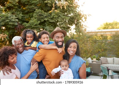 Portrait Of Multi-Generation African American Family Relaxing In Garden At Home Together