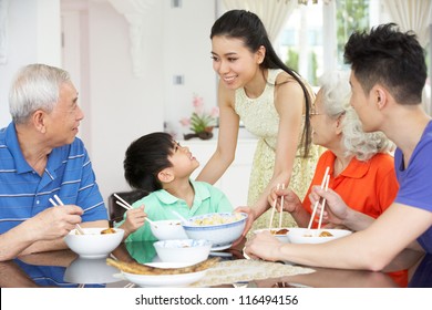 Portrait Of Multi-Generation Chinese Family Eating Meal Together