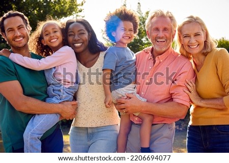 Portrait Of Multi-Generation Family At Home In Garden Together