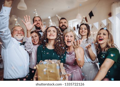 A Portrait Of Multigeneration Family With Presents On A Indoor Birthday Party.