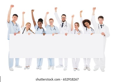 Portrait Of Multiracial Medical Team Holding Billboard Raising Their Arms