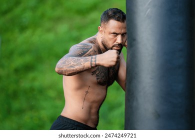 Portrait of muscular boxer. Man boxer face close up. Fists fight. Mans fight, punches. Kicks up. In the outdoor boxing arena. Man ready for boxings challenge. Man fight. Boxings fight. Boxing sport. - Powered by Shutterstock