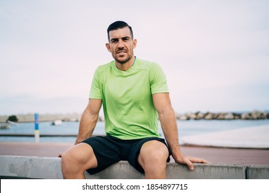 Portrait Of Muscular Male Jogger 30 Years Old Looking At Camera During Workout Break At Embankment, Strong Sportsman Dressed In Active Wear Keeping Healthy Lifestyle And Mental Vitality Wellness