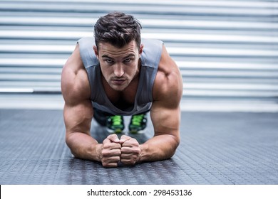 Portrait Of A Muscular Man On Plank Position