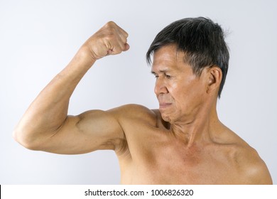 Portrait Of Muscular Naked Fit Strong Asian Chinese Middle Age Very Old Man Looking At The Camera. Show His Muscle. Yellow Brown Tan Skin. Healthy Concept. White Background.
