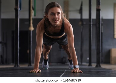 Portrait of a muscular woman on a plank position. - Shutterstock ID 1614687919