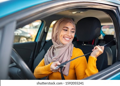 Portrait Of Muslim Asian Young Woman Driving Her Car. Arab Women Driving Car. Middle Eastern Woman Driving A Car, Looking Forward. Get Driving License Concept