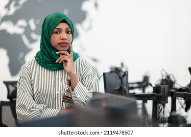 Portrait Of Muslim Black Female Software Developer With Green Hijab Standing At Modern Open Plan Startup Office. Selective Focus 