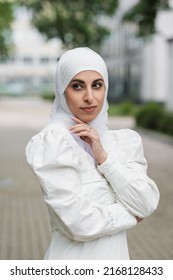 portrait of muslim bride in hijab with diamond ring on finger looking away